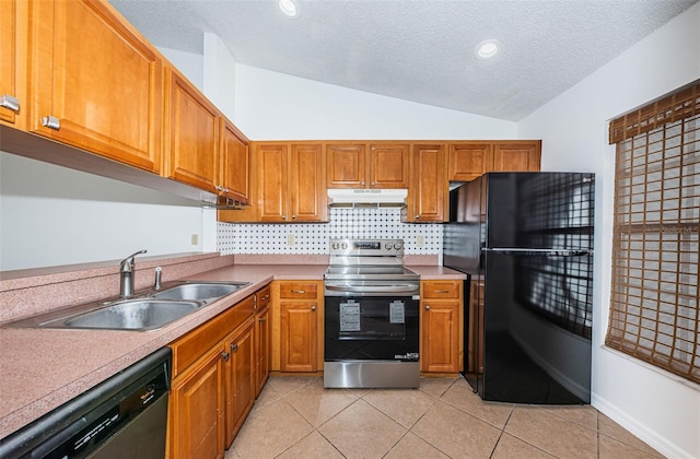 kitchen with a textured ceiling, sink, black appliances, light tile patterned floors, and lofted ceiling