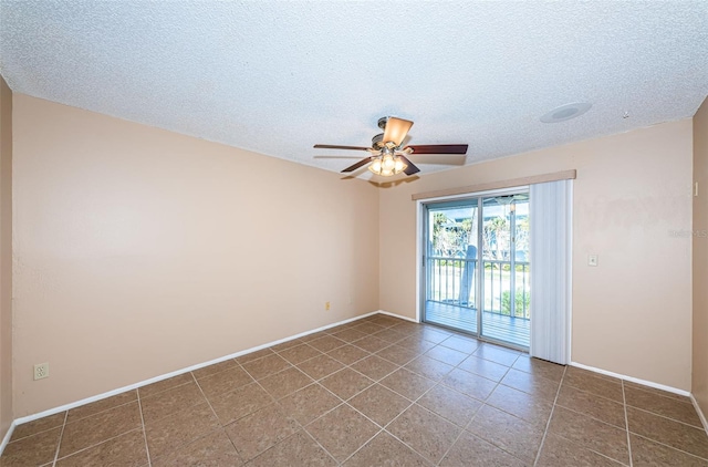 tiled spare room with ceiling fan and a textured ceiling