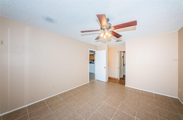 spare room with ceiling fan and a textured ceiling