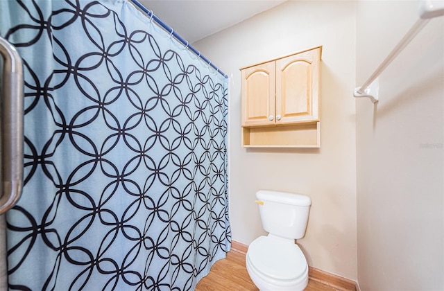 bathroom featuring hardwood / wood-style floors and toilet