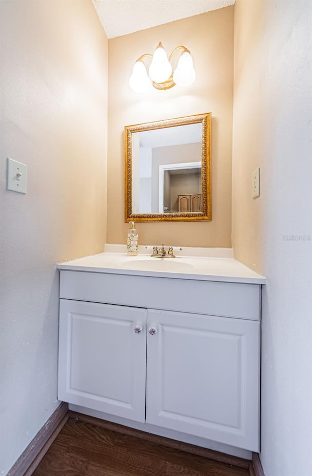 bathroom with vanity and hardwood / wood-style flooring