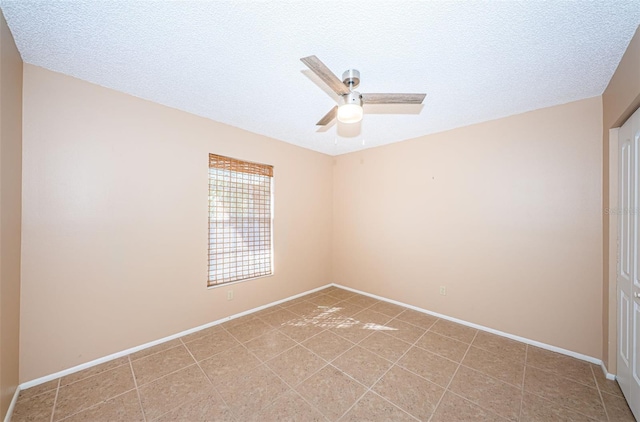 empty room featuring a textured ceiling and ceiling fan