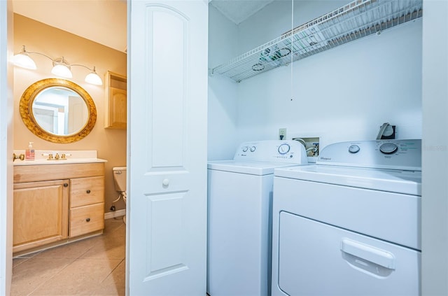 laundry area featuring washer and dryer and light tile patterned flooring