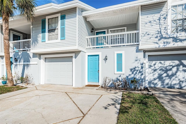 view of front of property with a balcony and a garage