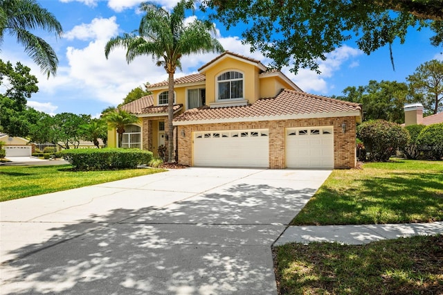 mediterranean / spanish home with a front yard and a garage