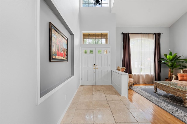 foyer entrance with light hardwood / wood-style flooring and a wealth of natural light