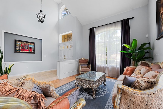 living room with light hardwood / wood-style flooring and high vaulted ceiling