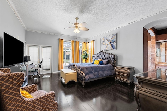 bedroom featuring a textured ceiling, dark hardwood / wood-style flooring, ceiling fan, and ornamental molding