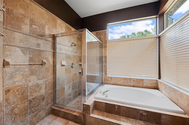 bathroom featuring plus walk in shower and a textured ceiling