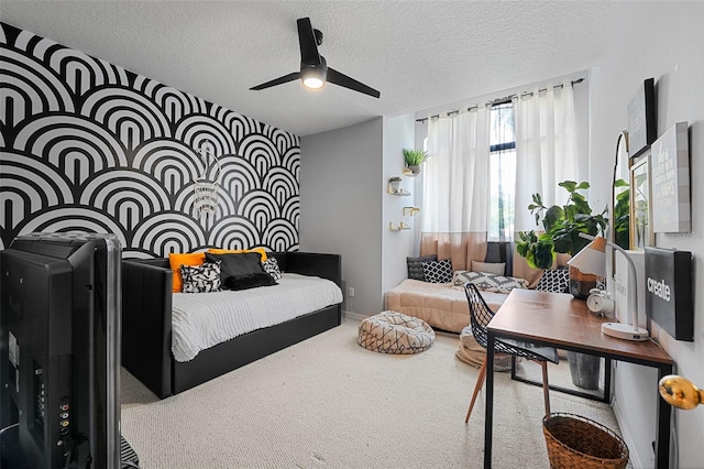 bedroom featuring carpet, ceiling fan, and a textured ceiling