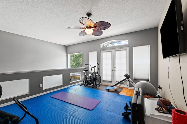 workout area featuring hardwood / wood-style floors, ceiling fan, a textured ceiling, and french doors