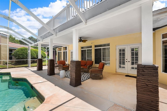 view of patio featuring outdoor lounge area, ceiling fan, french doors, and glass enclosure