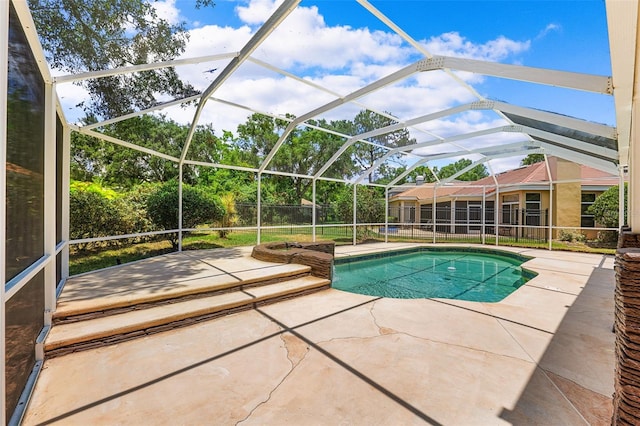 view of pool with a patio and a lanai