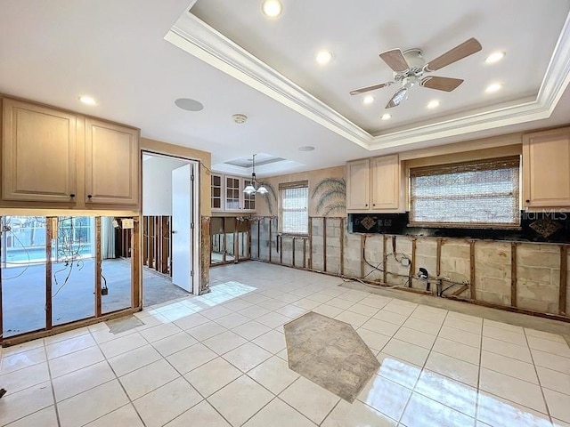 kitchen featuring light brown cabinetry, a tray ceiling, hanging light fixtures, and ceiling fan