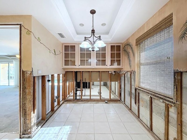 interior space with a tray ceiling and an inviting chandelier