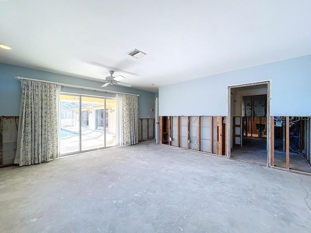 unfurnished room featuring ceiling fan and concrete flooring