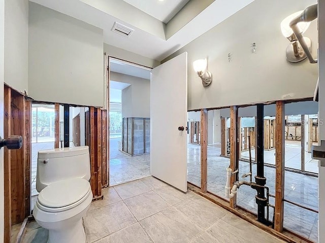 bathroom with toilet and tile patterned floors