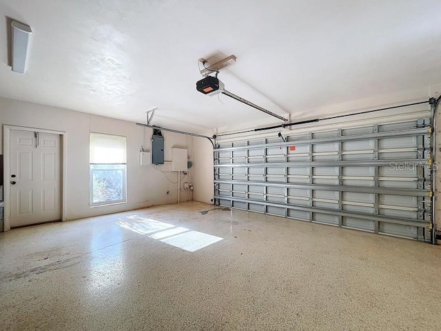 garage featuring electric panel and a garage door opener