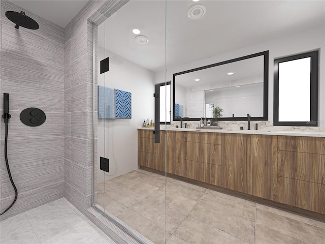 bathroom featuring tile patterned floors, vanity, a shower with door, and tile walls