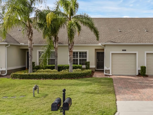 ranch-style home with a garage and a front yard