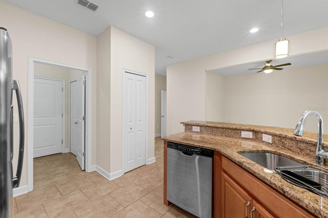 kitchen featuring ceiling fan, sink, light stone counters, stainless steel dishwasher, and refrigerator