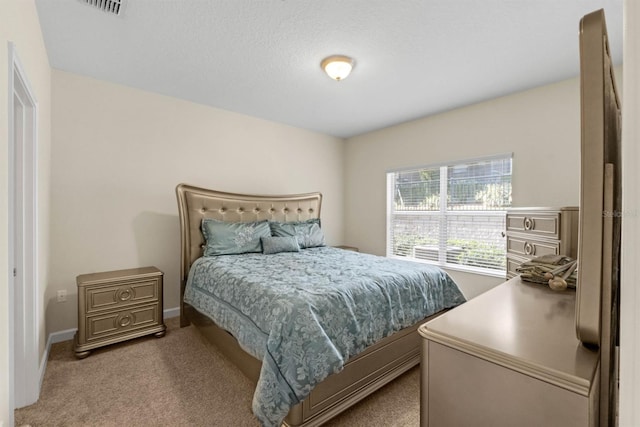 carpeted bedroom with a textured ceiling