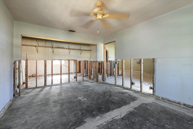 interior space with ceiling fan and a textured ceiling