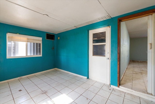 spare room featuring light tile patterned floors