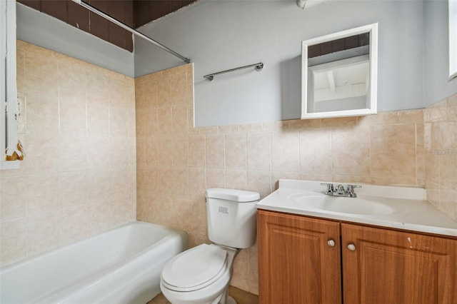 full bathroom with vanity, tile walls, and toilet