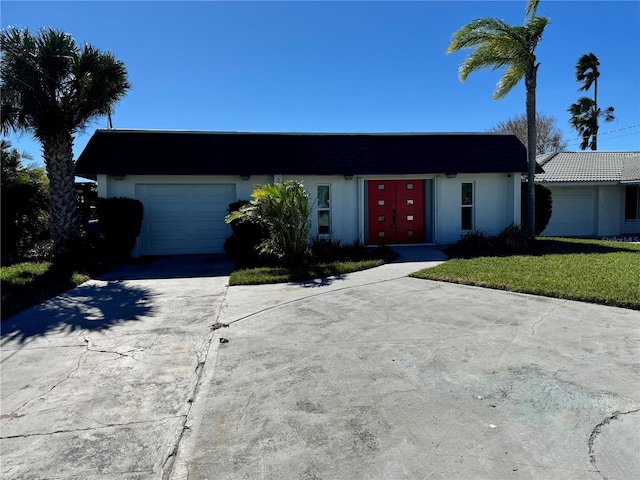 3960 Headsail Dr, New Port Richey, FL 34652 - view of front of property with concrete driveway, a garage, stucco siding, and a front yard