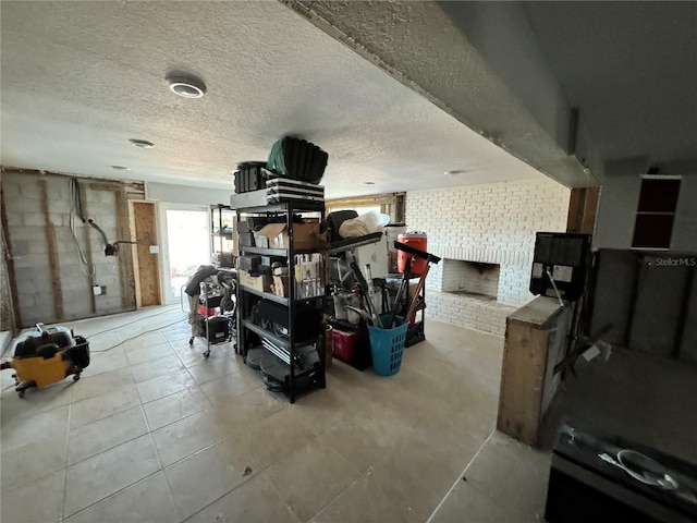 miscellaneous room with a textured ceiling and brick wall