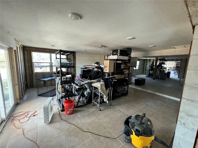 interior space featuring tile patterned flooring and a textured ceiling