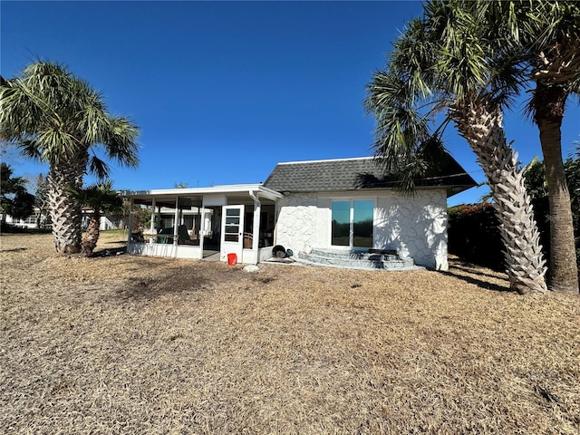 rear view of property with a sunroom