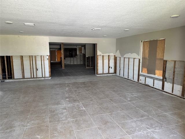 3960 Headsail Dr, New Port Richey, FL 34652 - empty room with a textured ceiling and tile patterned flooring