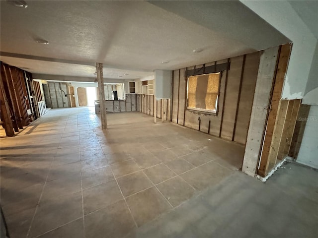 3960 Headsail Dr, New Port Richey, FL 34652 - basement with a textured ceiling and tile patterned floors