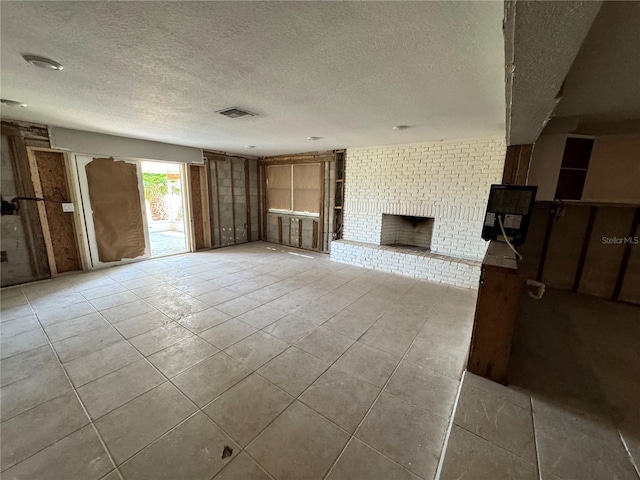 3960 Headsail Dr, New Port Richey, FL 34652 - unfurnished living room featuring a textured ceiling, tile patterned flooring, and a fireplace