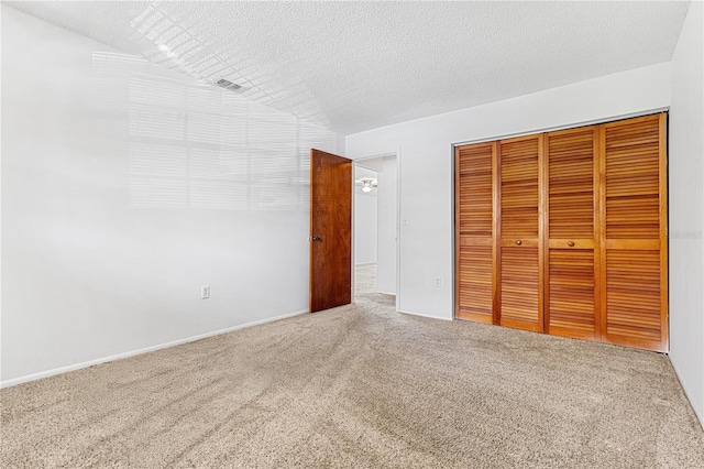 unfurnished bedroom with a closet, carpet, and a textured ceiling