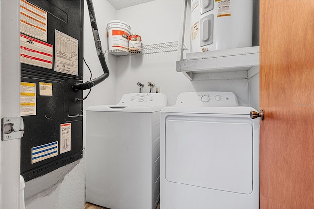 laundry room with washer and dryer and electric water heater