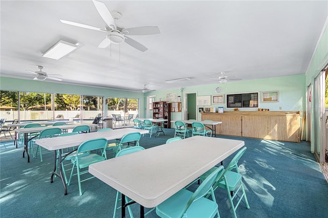 dining space with carpet flooring and ceiling fan