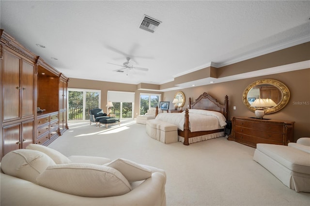 carpeted bedroom with access to outside, ceiling fan, a textured ceiling, and ornamental molding