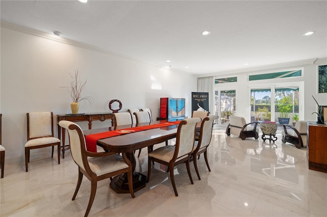 dining area featuring light tile patterned floors and crown molding