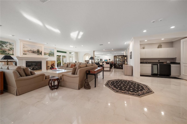 living room with sink and ornamental molding