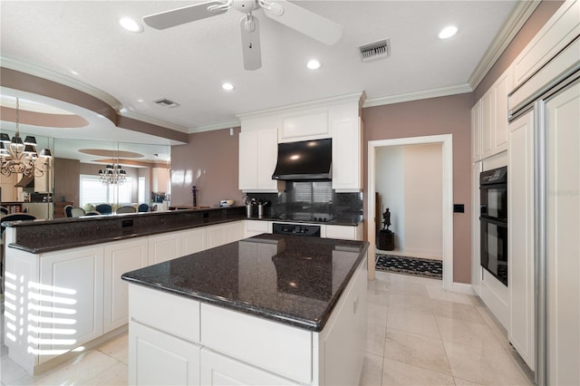 kitchen with kitchen peninsula, decorative backsplash, white cabinets, and crown molding