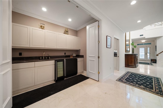 kitchen with french doors, crown molding, sink, white cabinets, and wine cooler