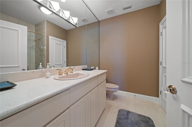 bathroom featuring tile patterned floors, vanity, an enclosed shower, and toilet