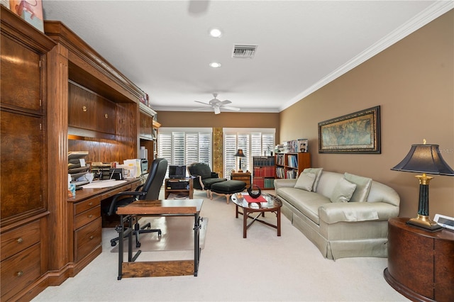 carpeted home office featuring ceiling fan and ornamental molding