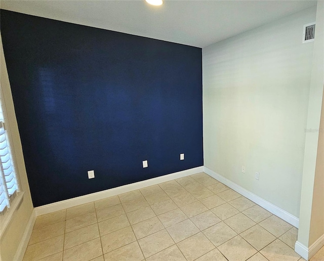 empty room featuring light tile patterned floors