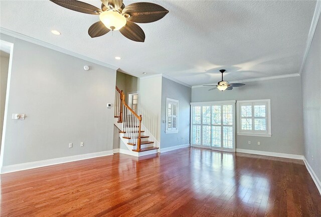 spare room with wood-type flooring, a textured ceiling, ceiling fan, and ornamental molding