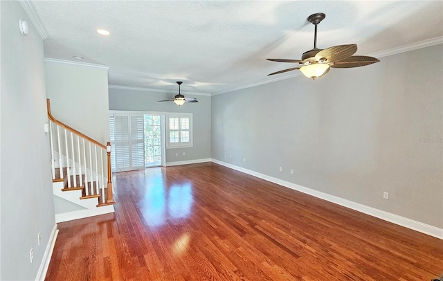 unfurnished living room featuring wood-type flooring, a textured ceiling, ceiling fan, and ornamental molding