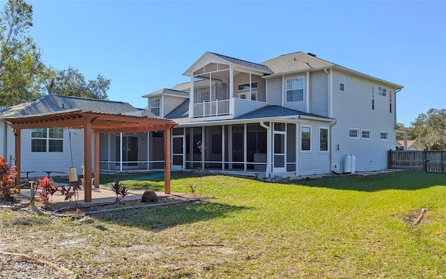 back of house with a yard and a balcony